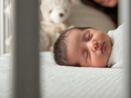How to Choose the Best Baby Crib for Newborns (Step-by-Step Guide) newborn sleeping safely in a crib while a parent watches calmly nearby