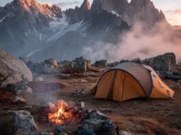 Essential Camping Gear Checklist for Your Mountain Tent Adventure Mountain camping gear setup with tent and backpack at sunrise
