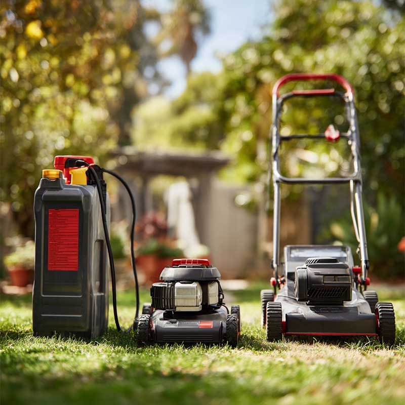 comparison of gas, corded electric, and battery-powered outdoor tools in backyard