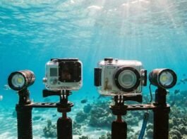 Action camera and compact camera used underwater, showing differences in size, controls, and shooting style