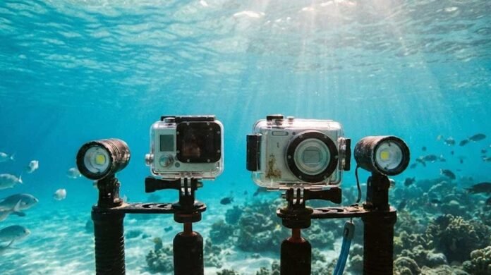 Action camera and compact camera used underwater, showing differences in size, controls, and shooting style