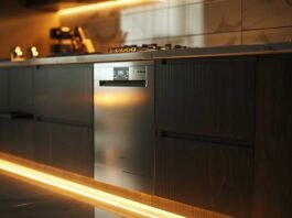 tainless steel dishwasher running overnight in a modern kitchen with soft ambient light